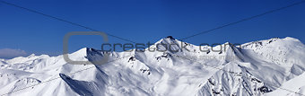 Panoramic view on off-piste slopes and blue sky at nice day