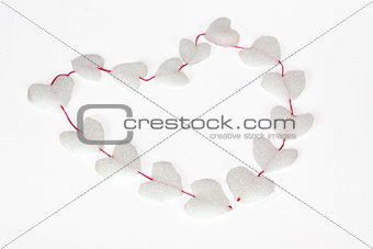 Heart shape of many white styrofoam figures with red thread