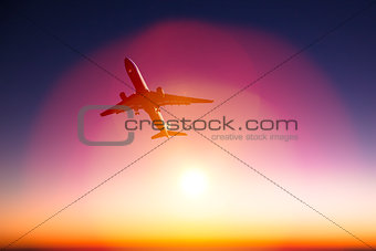 airplane with beautiful orange sunset background