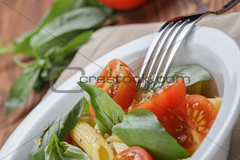 simple italian pasta penne with tomatoes and basil