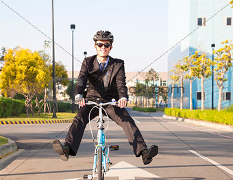 businessman riding bicycle to office for eco-friendly