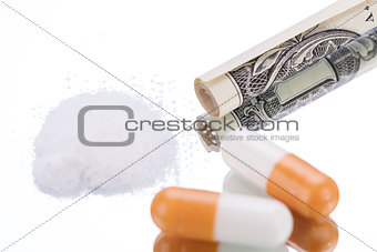 illegal pharmaceutical pills and drugs money on mirror