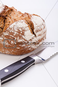 fresh baked grain bead and knife isolated