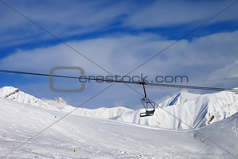 Chair lift and off-piste slope at nice day
