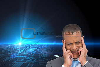 Composite image of stressed businessman putting his fingers on his temples