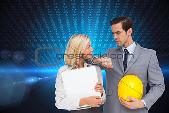 Composite image of architects with plans and hard hat looking at each other