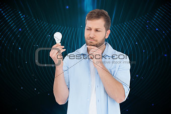 Composite image of sceptical model holding a bulb