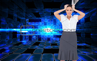 Composite image of worried stylish businesswoman holding newspaper