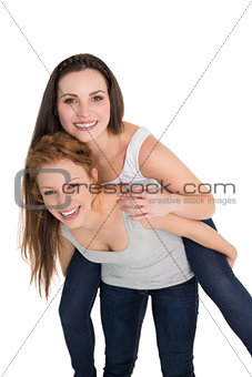 Portrait of a young female piggybacking friend