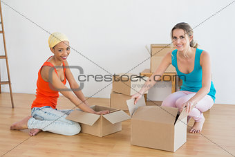 Friends unwrapping boxes in a new house