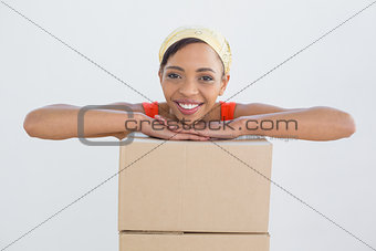 Portrait of a smiling young woman with boxes