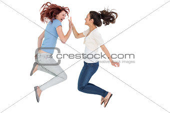 Happy young female friends playing clapping game