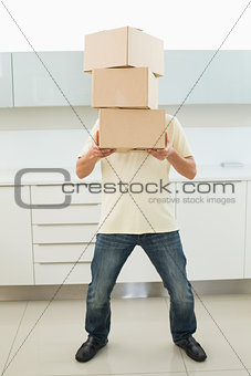 Full length of man carrying boxes in front of his face