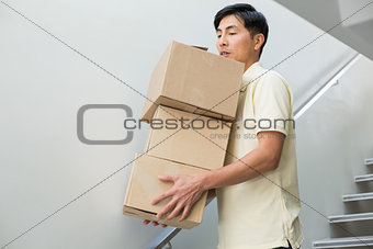 Young man carrying boxes
