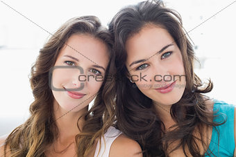 Close-up portrait of two smiling young female friends