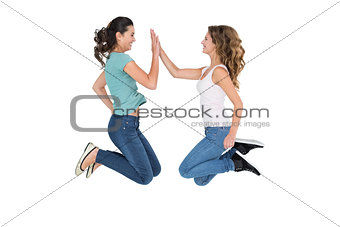 Young female friends playing clapping game
