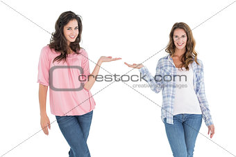 Female friends holding out their hands