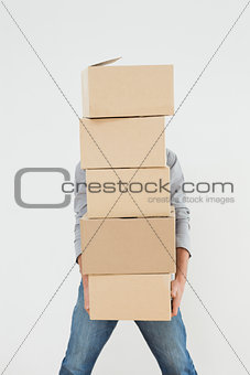Obscured man carrying boxes
