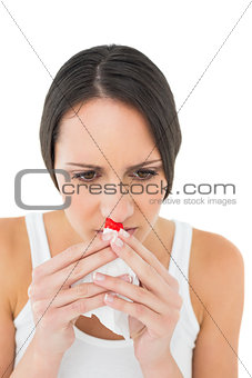 Brunette woman having a nose bleed