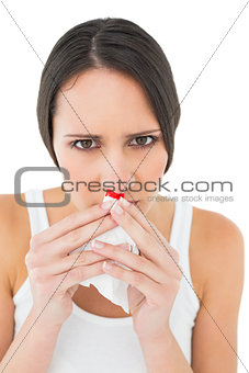 Close-up portrait of a young woman with bleeding nose