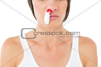 Close-up of a young woman with bleeding nose
