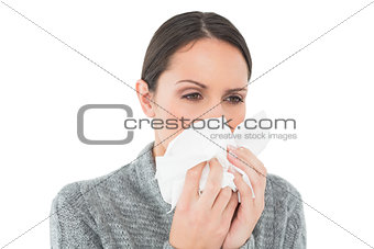 Close-up of a casual young woman suffering from cold