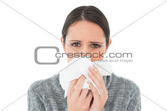 Portrait of a casual young woman suffering from cold