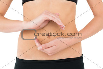Close-up mid section of a fit woman with hand gestures