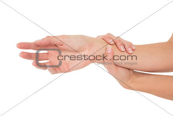 Close-up of a young woman touching her wrist