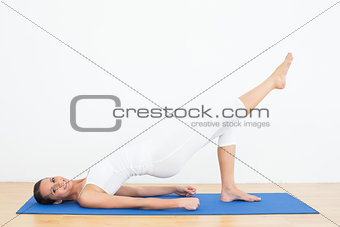 Fit woman doing pilate exercises in the fitness studio