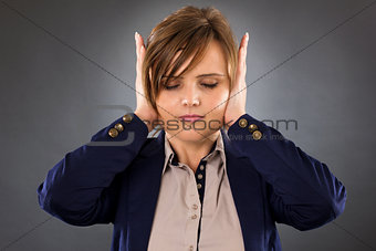Closeup portrait of a young businesswoman covering ears with her