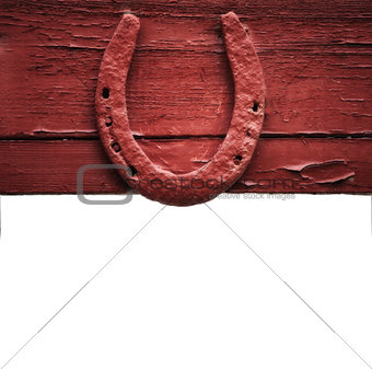 The old horseshoe hanging on wooden wall