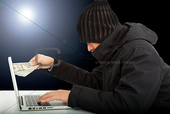 Computer hacker stealing money  in the darkness