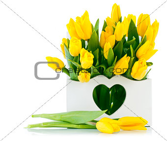 spring yellow tulips in wooden basket