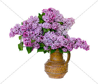 Spring lilac bouquet in clay vase.