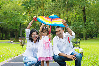 Parents flying kite with child