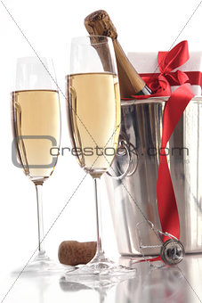 Glasses of champagne for Valentine's day with gift and ribbon