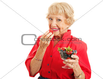 Fit Healthy Senior Lady Eating Berries
