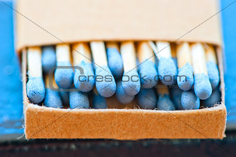 matchbox with blue heads closeup 