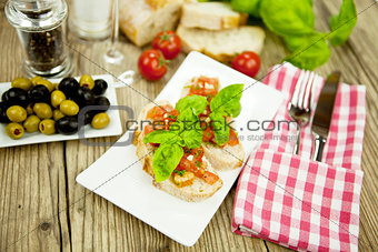 fresh tasty italian bruschetta with tomato on table