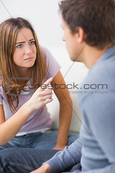 Angry couple having an argument in their living room