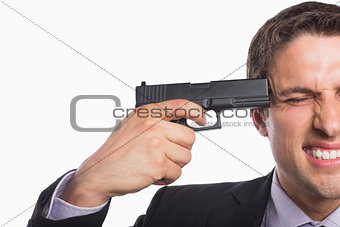 Close-up of a businessman holding a gun to head