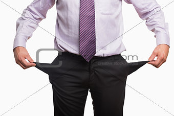 Mid section of a businessman with pockets pulled out