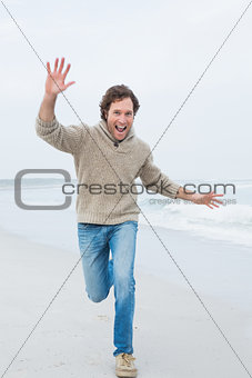 Full length of a casual man running at beach