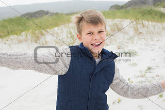 Cheerful boy running at beach