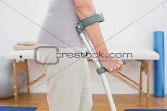 Close-up mid section of a woman with crutches