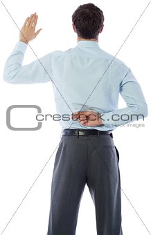Businessman crossing fingers behind his back