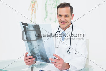 Portrait of a smiling male doctor with x-ray picture