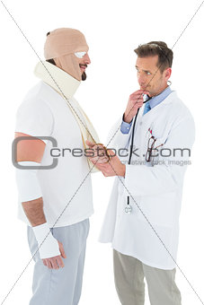 Doctor looking at patient tied up in bandage
