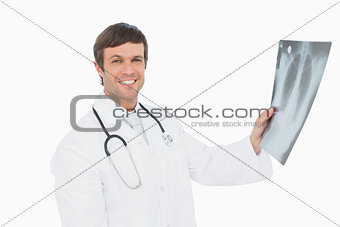 Smiling male doctor holding an x-ray picture of lungs